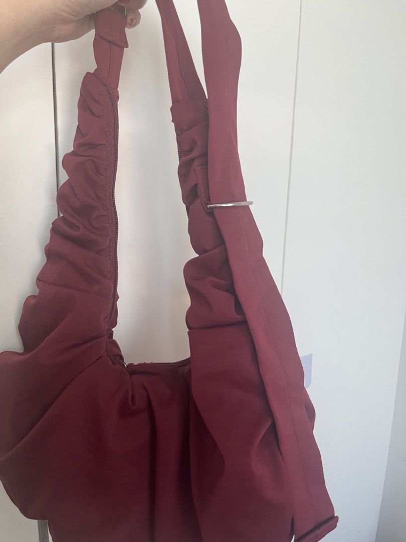 Maroon Ruched Shoulder Bag (Category: Shoulder Bags) located in Mandaluyong City. Submitted by jackiemochi (Listing ID 1463171351, Image 2). Description: - Stylish maroon shoulder bag - Unique ruched detailing all over - Secure top zipper closure - Adjustable strap with buckle for a custom fit - Convenient interior pockets - Ideal for everyday wear.
