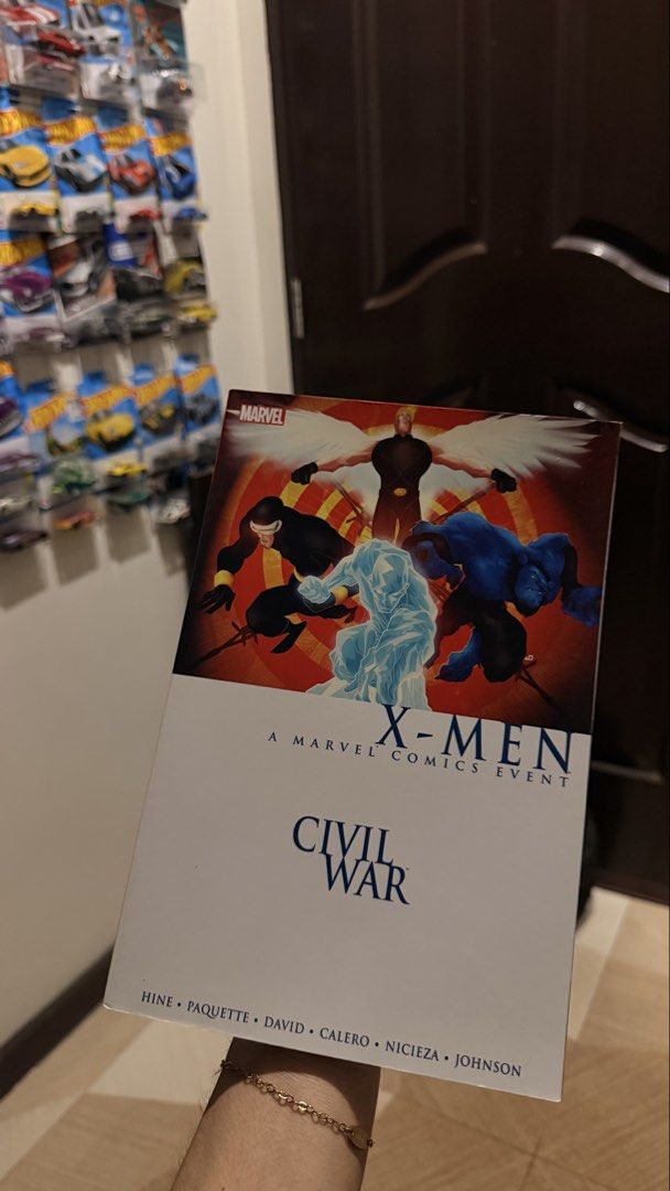 Marvel X-Men Civil War Graphic Novel (Category: Comics & Manga) located in San Fernando. Submitted by goodiespin (Listing ID 1463269835, Image 1). Description: - Marvel Comics X-Men Civil War graphic novel - Features iconic characters: Cyclops, Angel, Beast, and Iceman - A key Marvel Comics event - Written by Hine, Paquette, David, Calero, Nicieza, and Johnson - Perfect addition to any Marvel fan's collection.