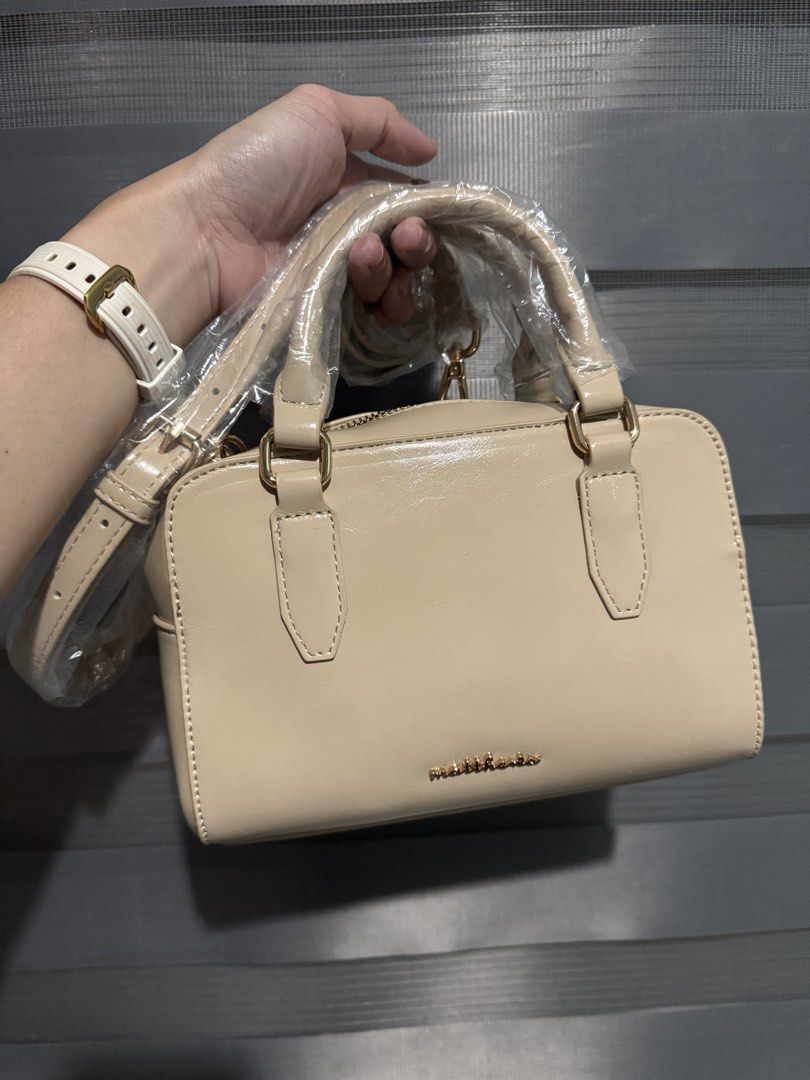 Matthews Beige Patent Leather Top Handle Bag (Category: Shoulder Bags) located in Taguig. Submitted by grayanna (Listing ID 1463248913, Image 1). Description: - Beige patent leather handbag - Brand: Matthews -Daria - Top handles - Detachable shoulder strap - Includes original dust bag - Tag still attached.