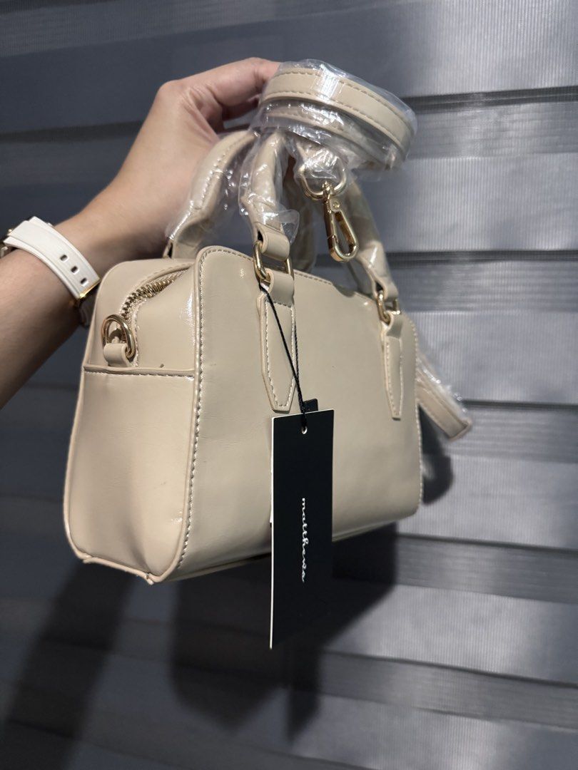 Matthews Beige Patent Leather Top Handle Bag (Category: Shoulder Bags) located in Taguig. Submitted by grayanna (Listing ID 1463248913, Image 2). Description: - Beige patent leather handbag - Brand: Matthews -Daria - Top handles - Detachable shoulder strap - Includes original dust bag - Tag still attached.