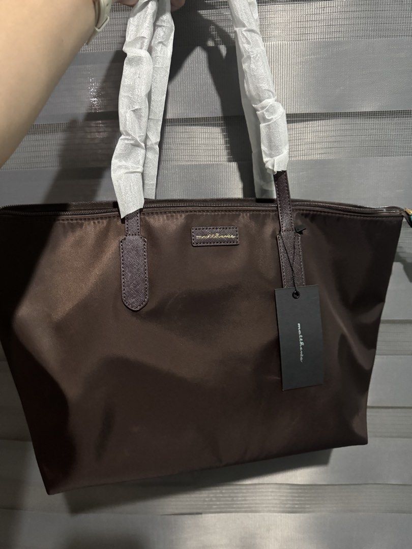 Matthews Tote Bag - Brown Nylon (Category: Tote Bags) located in Taguig. Submitted by grayanna (Listing ID 1463248548, Image 1). Description: - Brand: Matthews - Color: Brown - Material: Nylon - Features: Zippered main compartment, interior zip pocket - Condition: Handles still wrapped in plastic, includes original tag - Ideal for: Everyday use.
