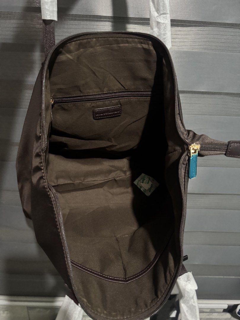 Matthews Tote Bag - Brown Nylon (Category: Tote Bags) located in Taguig. Submitted by grayanna (Listing ID 1463248548, Image 2). Description: - Brand: Matthews - Color: Brown - Material: Nylon - Features: Zippered main compartment, interior zip pocket - Condition: Handles still wrapped in plastic, includes original tag - Ideal for: Everyday use.