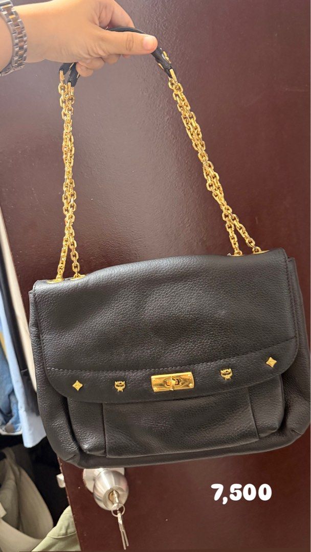 MCM Black Leather Chain Shoulder Bag (Category: Luxury Bags & Wallets) located in Santa Rosa. Submitted by hello2ndhandlove (Listing ID 1463141624, Image 2). Description: - Authentic black leather MCM shoulder bag - Elegant gold chain strap - Signature MCM logo studs for a touch of luxury - Secure and stylish twist-lock closure - Spacious interior for your daily essentials - Versatile design, perfect for both daytime and evening use.