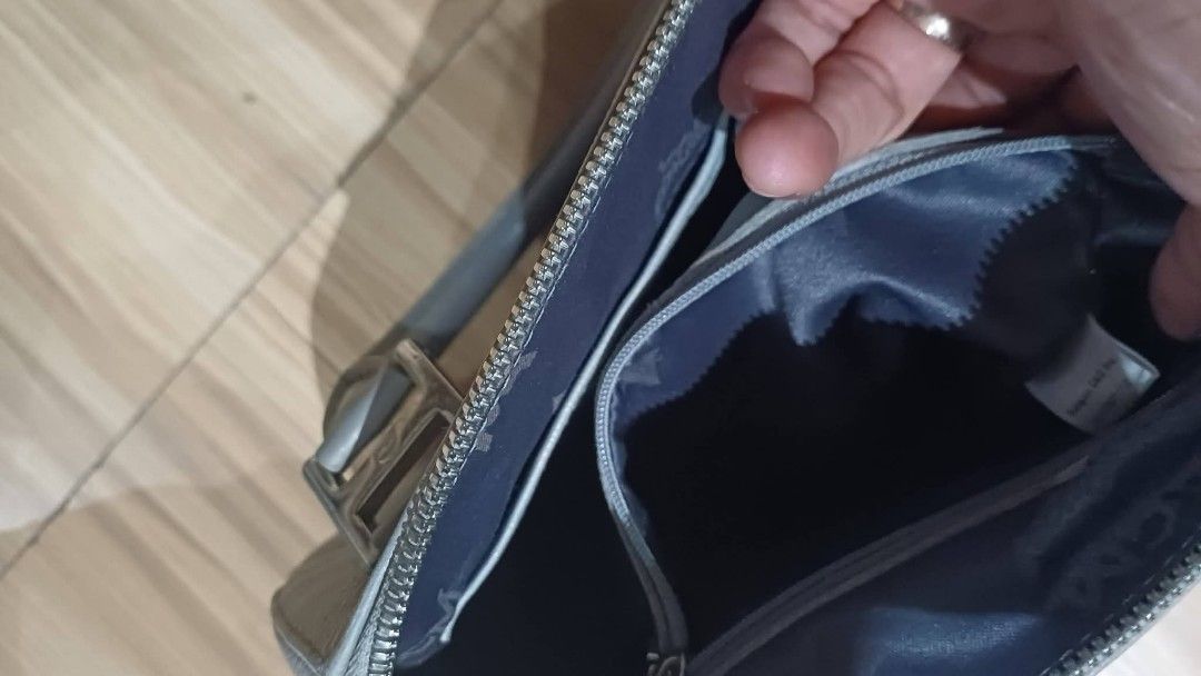 MCM Grey Leather Handbag (Category: Luxury Bags & Wallets) located in Bay. Submitted by silverhorse-59c851 (Listing ID 1463244954, Image 2). Description: - Authentic MCM handbag - Color: Grey - Material: Leather - Signature MCM logo on front and interior - Secure zipper closure - Comfortable top handles - Interior pockets for organization - Ideal size for daily use.
