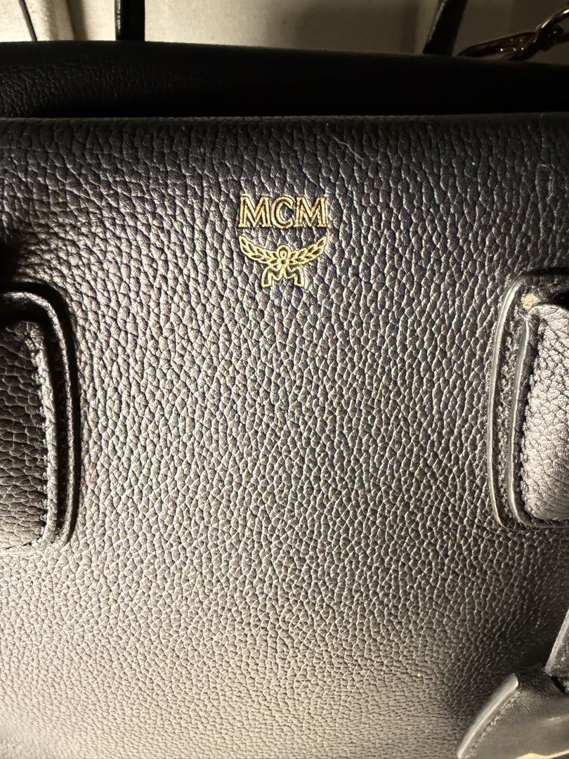 MCM Milla Bag (Category: Luxury Bags & Wallets) located in Quezon City. Submitted by arterg (Listing ID 1463230361, Image 1). Description: Bought US The leather tote features brass hardware and an contrasting color removable shoulder strap with an 18" drop. While simple, the overall design is clean and luxurious with dimensions that make it perfect for everyday use. • black • top handle • logo detail • gold-tone hardware Outer: Calf Leather 100% 