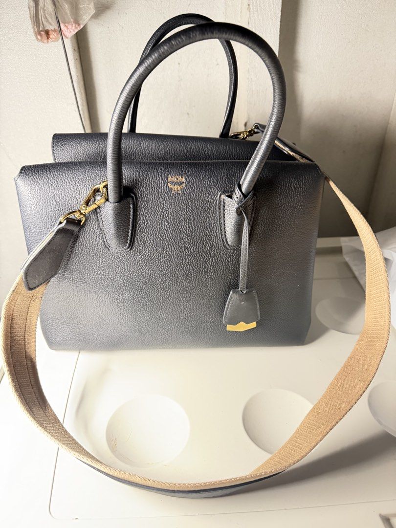 MCM Milla Bag (Category: Luxury Bags & Wallets) located in Quezon City. Submitted by arterg (Listing ID 1463230361, Image 2). Description: Bought US The leather tote features brass hardware and an contrasting color removable shoulder strap with an 18" drop. While simple, the overall design is clean and luxurious with dimensions that make it perfect for everyday use. • black • top handle • logo detail • gold-tone hardware Outer: Calf Leather 100% 