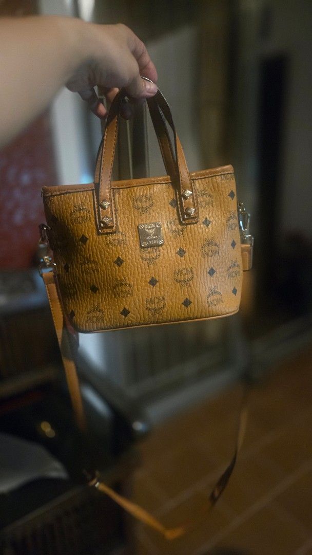 MCM Monogram Mini Handbag (Category: Luxury Bags & Wallets) located in Paranaque City. Submitted by itsmemichel (Listing ID 1463292107, Image 2). Description: - Cute MCM mini handbag - All-over monogram print - Tan leather trim and handles - Small metal logo plate on the front - Detachable strap included - Ideal for carrying your essentials.