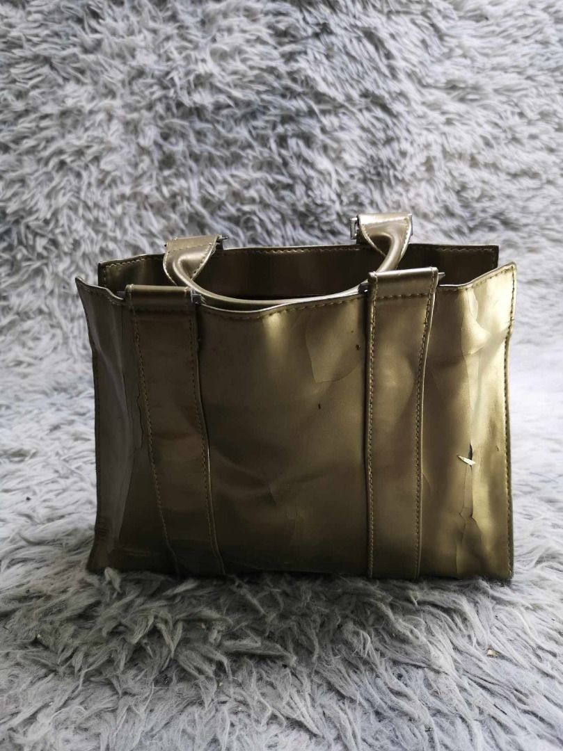 Metallic Gold Tone Structured Top Handle Tote Bag (Category: Tote Bags) located in Santa Cruz. Submitted by jmy_surplus.2 (Listing ID 1463124528, Image 3). Description: Size ; L - 7.6 W - 9.6 Color ; Gold Type ; Tote Bag Brand ; No brand Material ; Synthetic Style ; Metallic Gold Tote Bag LR 129 JMY 3 Batch #223.