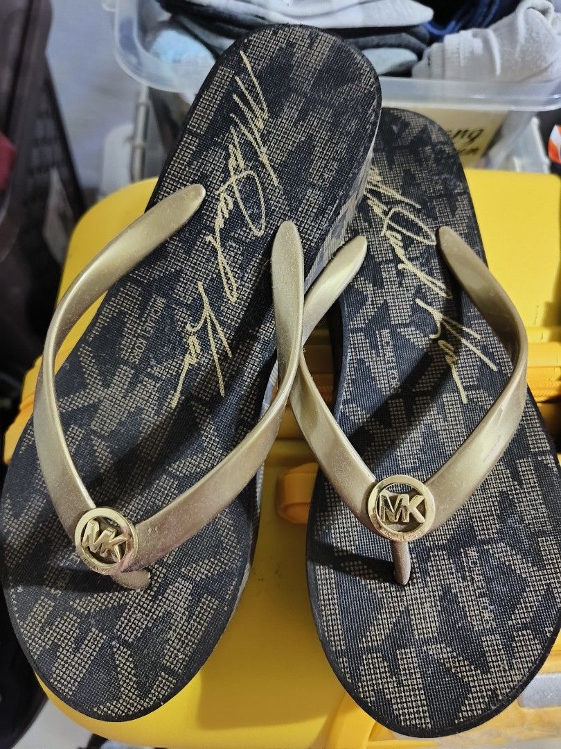 Michael Kors MK Logo Flip-Flops (Category: Slippers and slides) located in Manila. Submitted by jhinesquivel (Listing ID 1463125081, Image 1). Description: - Authentic Michael Kors flip-flops - Chic gold and black colorway - All-over signature MK logo pattern - Metallic gold straps with MK logo charm - Ideal for casual wear, beach, or poolside - Easy slip-on design for convenience.