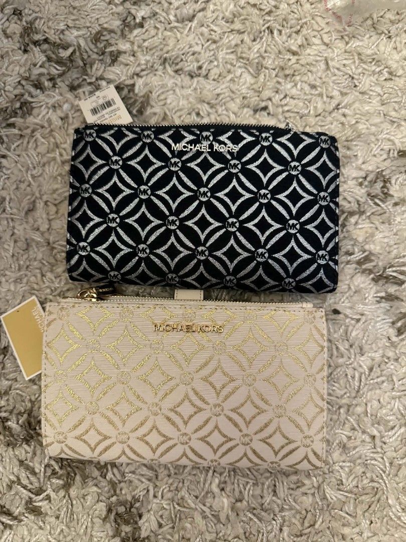 Michael Kors MK Signature Pouches (Category: Purses & Pouches) located in Quezon City. Submitted by thriftshopmar (Listing ID 1463246521, Image 1). Description: - Two Michael Kors pouches available. -Bought from U.S. - Option 1: Black with silver MK pattern. - Option 2: Cream with gold MK pattern. - Both feature secure zip closures. - Accented with elegant gold hardware. - Brand new with original tags still attached. - Ideal for organizing small 