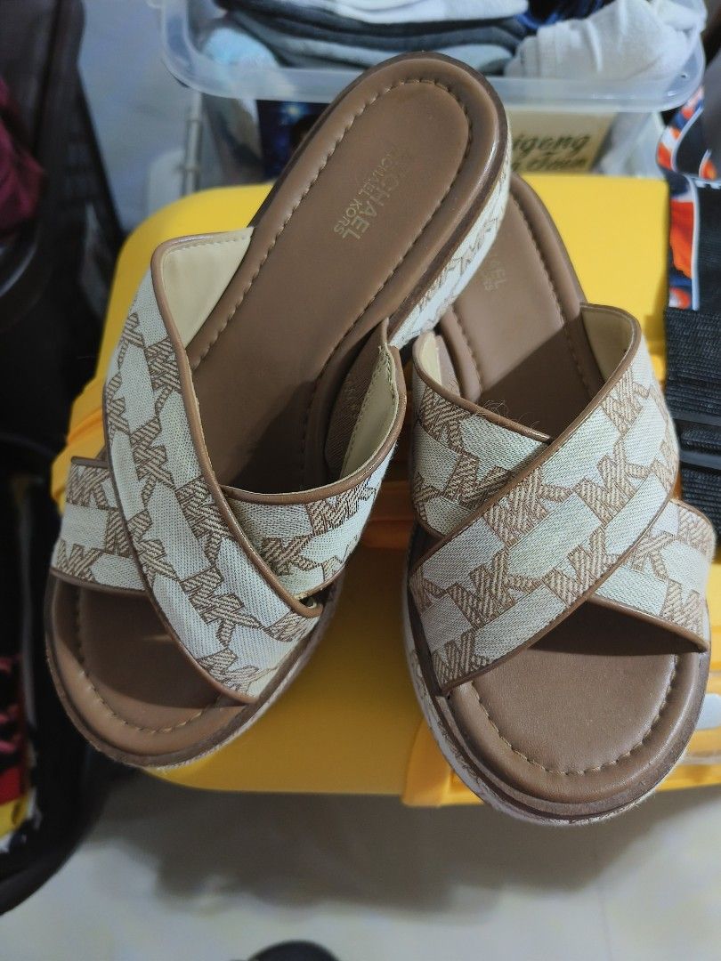 Michael Kors Monogram Wedge Sandals (Category: Wedges) located in Manila. Submitted by jhinesquivel (Listing ID 1463124895, Image 1). Description: - Authentic Michael Kors wedge sandals - Features iconic MK monogram pattern - Stylish brown and cream colorway - Easy slip-on design - Comfortable platform sole for added height - Ideal for everyday casual wear.