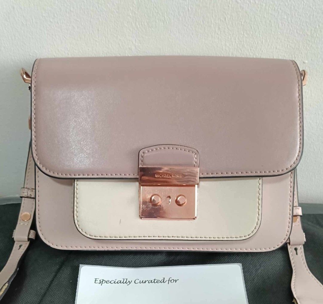 Michael Kors Pink Shoulder / Body Bag (Category: Luxury Bags & Wallets) located in Marikina City. Submitted by bloomsandgreenscollection (Listing ID 1463284272, Image 3). Description: - Michael Kors shoulder bag with adjustable guitar strap - Color: Pink and cream - Bright Rose gold hardware - Minor issue in the last pic - Bought from Tokyo Curations Live Selling - Japan pre-loved bag - RFS: need bigger bags.