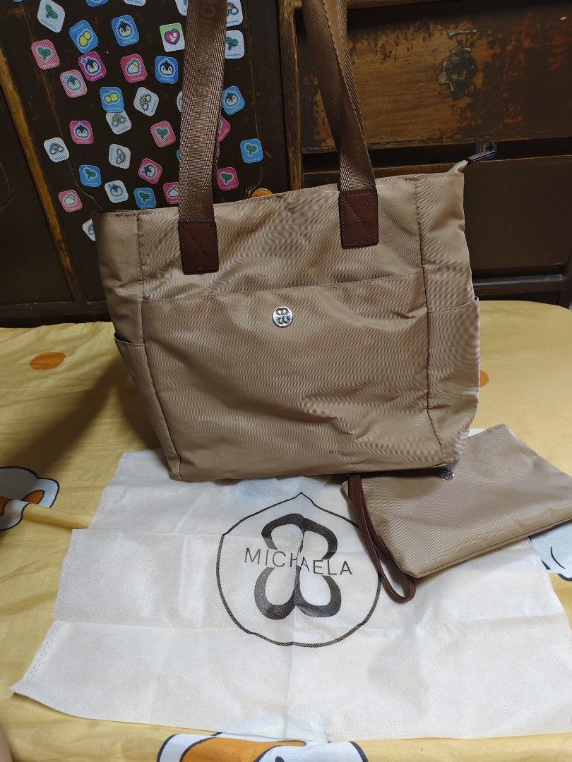 Michaela Tote Bag with Pouch (Category: Tote Bags) located in General Mariano Alvarez. Submitted by findsandmoreph (Listing ID 1463175361, Image 1). Description: - Lightweight Michaela tote bag - Comes with a matching pouch - Zippered main compartment - Exterior pockets for easy access - Comfortable straps for easy carrying - Ideal for everyday use or travel - Versatile neutral color - Includes original dust bag.