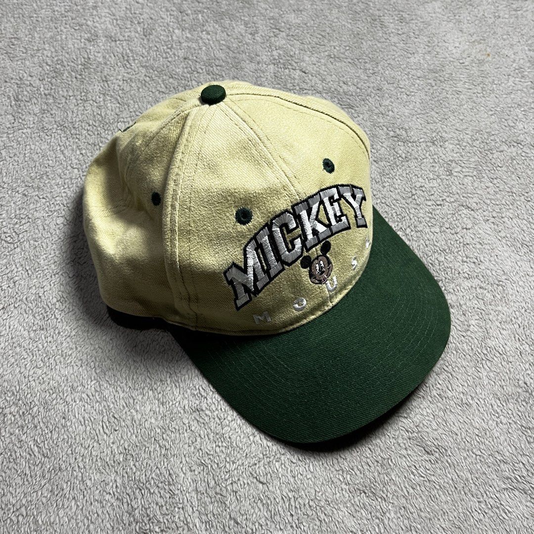 Mickey Unlimited Disney Baseball Cap (Category: Caps & Hats) located in Manila. Submitted by thrifted4life (Listing ID 1463244543, Image 1). Description: - Vintage Mickey Unlimited cap - Classic Mickey Mouse embroidered logo - Two-tone: Light yellow crown, dark green brim - Material: 100% Cotton - Size: One size fits all - Ideal for Disney enthusiasts.