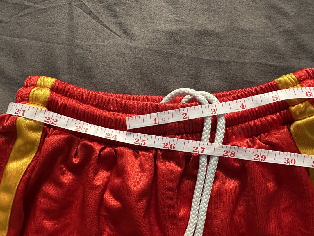 Microshiny Red & Yellow Basketball Shorts (Category: Shorts) located in Manila. Submitted by shoriljane (Listing ID 1463237356, Image 3). Description: - Red Nike basketball shorts - Yellow trim detail - Elastic waistband with drawstring - Visible Nike logo on left leg - Light pink interior lining - Ideal for sports and casual wear - Approximate measurements: 15" length, 22-30" waist.