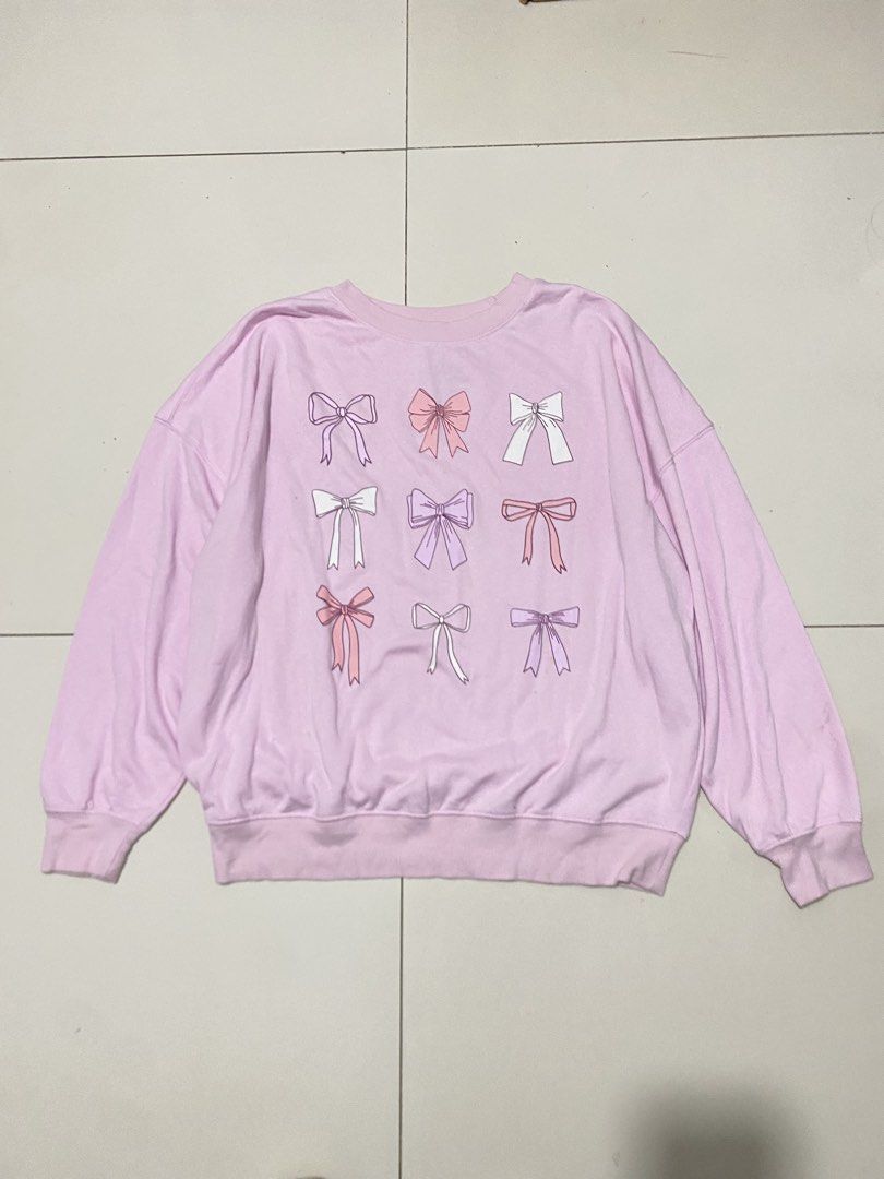 Mighty Fine Pink Bow Print Sweatshirt L (Category: Longsleeves) located in Baguio. Submitted by _strawberrymilk_ (Listing ID 1463320631, Image 1). Description: - Adorable pink sweatshirt - Features a charming all-over print of pastel-colored bows - Classic crew neck and long sleeves - Comfortable cotton blend fabric - Ideal for everyday casual wear.
