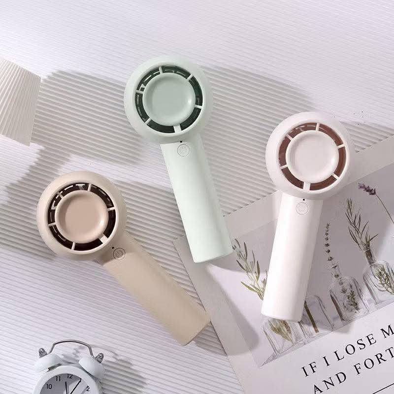 Mini Handheld Portable Fan with Lanyard (Category: Fans) located in Manila. Submitted by iliasjen3082126 (Listing ID 1463216536, Image 1). Description: - Cute and portable fan for on-the-go cooling. - Available in stylish pastel green, beige, and cream colors. - Includes a lanyard for convenient carrying. - Compact size easily fits in your bag. - Simple one-button operation. - Ideal for hot weather or stuffy indoor spaces..