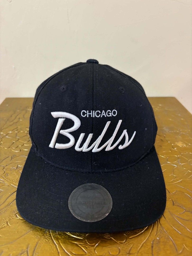 Mitchell & Ness Chicago Bulls Snapback Cap (Category: Caps & Hats) located in Daet. Submitted by jemotovlog28 (Listing ID 1463285422, Image 1). Description: - Brand: Mitchell & Ness - Team: Chicago Bulls - Color: Black - Features: Embroidered 'Chicago Bulls' logo on front - Closure: Adjustable snapback - Origin: Made in Vietnam - Condition: Shows some signs of wear on the brim and inside.