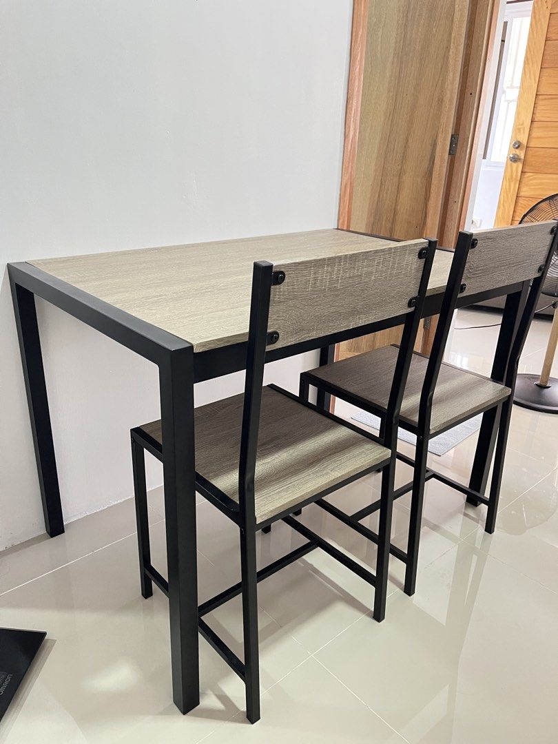 Modern 4-Seater Dining Table and Chairs Set (Category: Tables & Sets) located in Manila. Submitted by curated.clutter12 (Listing ID 1463282809, Image 2). Description: 🚨 RUSH SALE / MOVING OUT 🚨 Reason for Selling: Moving out and clearing spaces, needing funds ASAP! Letting go of this gorgeous, super practical 4-Seater Space-Saving Dining Set! Very modern and elegant Ash Wood/Gray tone with minimalist industrial black iron framing. Super perfect