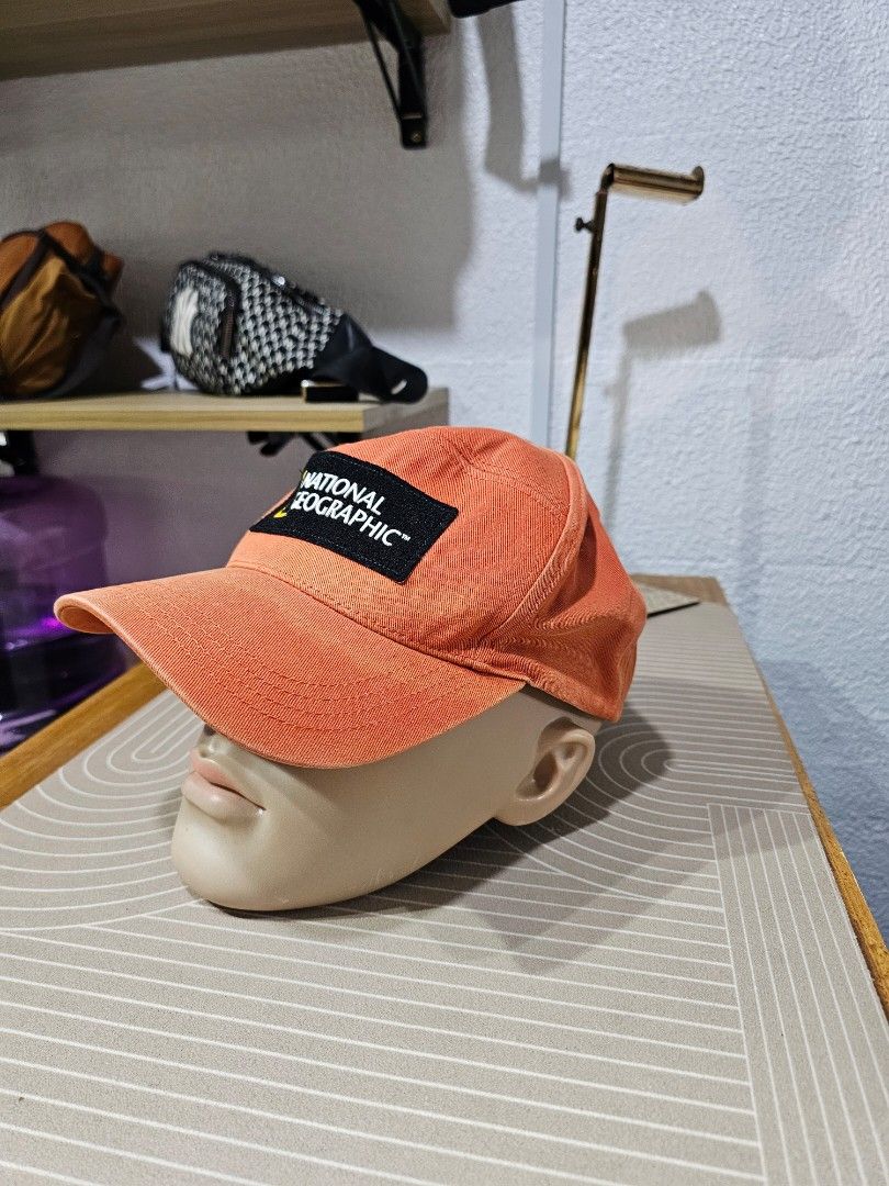 National Geographic panel cap (Category: Caps & Hats) located in Baguio. Submitted by kayeonlineshop (Listing ID 1463182266, Image 3). Description: -orange National Geographic panel cap featuring a prominent black and yellow brand patch on the front. Ask a follow-up.