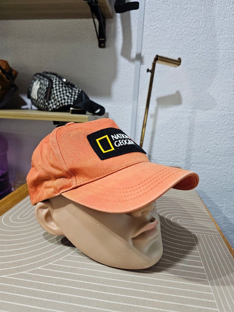 National Geographic panel cap (Category: Caps & Hats) located in Baguio. Submitted by kayeonlineshop (Listing ID 1463182266, Image 2). Description: -orange National Geographic panel cap featuring a prominent black and yellow brand patch on the front. Ask a follow-up.