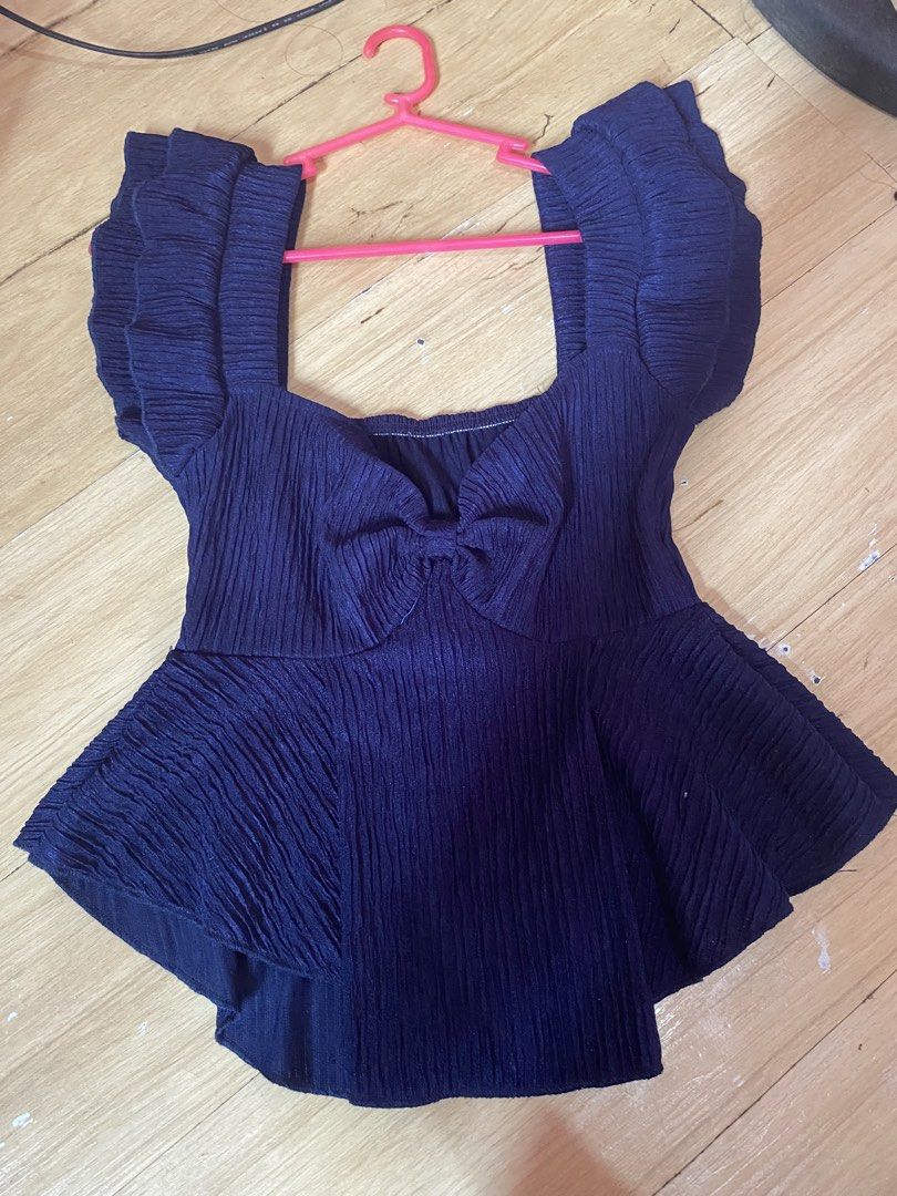 Navy Blue Peplum Top with Bow Detail (Category: Sleeveless) located in Tanauan. Submitted by rie098 (Listing ID 1463276708, Image 2). Description: - Navy blue peplum top - Square neckline with front bow detail - Ruffled short sleeves - Textured fabric - Versatile for dressing up or down.