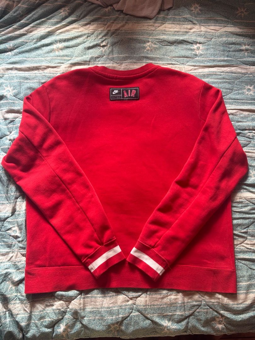 Nike Air Red Crewneck Sweatshirt (Category: Coats, Jackets and Outerwear) located in Baguio. Submitted by ssshhhaae (Listing ID 1463131302, Image 2). Description: - Authentic Nike Air crewneck sweatshirt - Features the classic Nike Air logo prominently on the chest - Ribbed cuffs and hem for a comfortable fit - Stylish white stripe detail on cuffs and hem - Ideal for everyday casual wear.