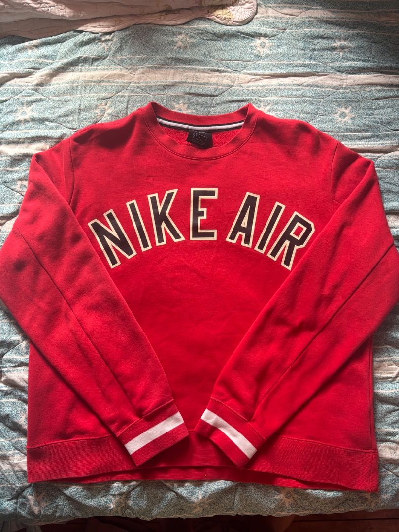 Nike Air Red Crewneck Sweatshirt (Category: Coats, Jackets and Outerwear) located in Baguio. Submitted by ssshhhaae (Listing ID 1463131302, Image 1). Description: - Authentic Nike Air crewneck sweatshirt - Features the classic Nike Air logo prominently on the chest - Ribbed cuffs and hem for a comfortable fit - Stylish white stripe detail on cuffs and hem - Ideal for everyday casual wear.