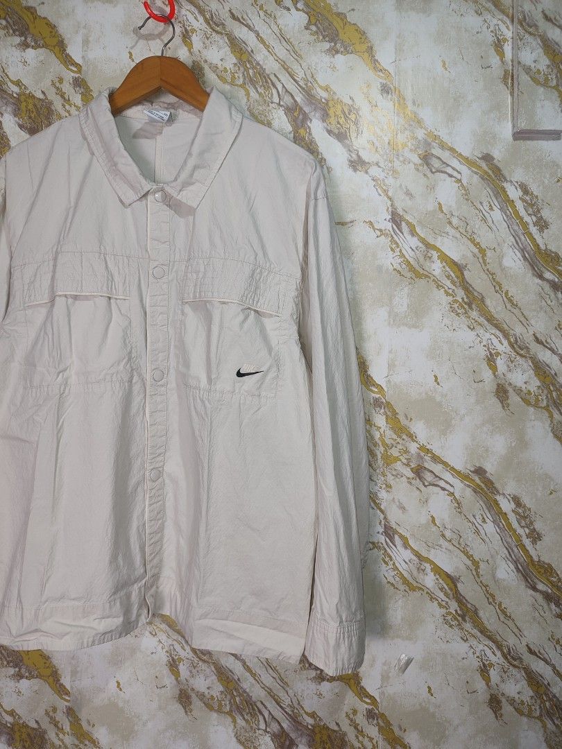 Nike Beige Lightweight Jacket with Swoosh Logo (Category: Coats, Jackets and Outerwear) located in Cabuyao City. Submitted by jederama (Listing ID 1463151967, Image 2). Description: NIKE WOVEN LONGSLEEVE AUTUMN SIZE : BEST FIT XL WIDTH - 23.5 LENGTH - 27 EXCELLENT CONDITION NO ISSUE / NO FLAWS AUTHENTIC 💯 1,200 + SHIPPING FEE.