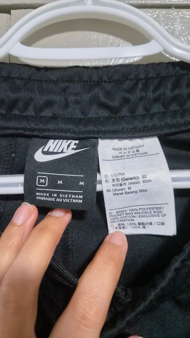 Nike Black Track Pants Original (Category: Joggers) located in Quezon City. Submitted by mimi0024 (Listing ID 1463169685, Image 2). Description: - Black Nike track pants - Classic white stripes down the sides - Elastic waistband with drawstring for a comfortable fit - Ribbed cuffs at the ankles - Made in Vietnam - Size M - Great for sports or casual wear.