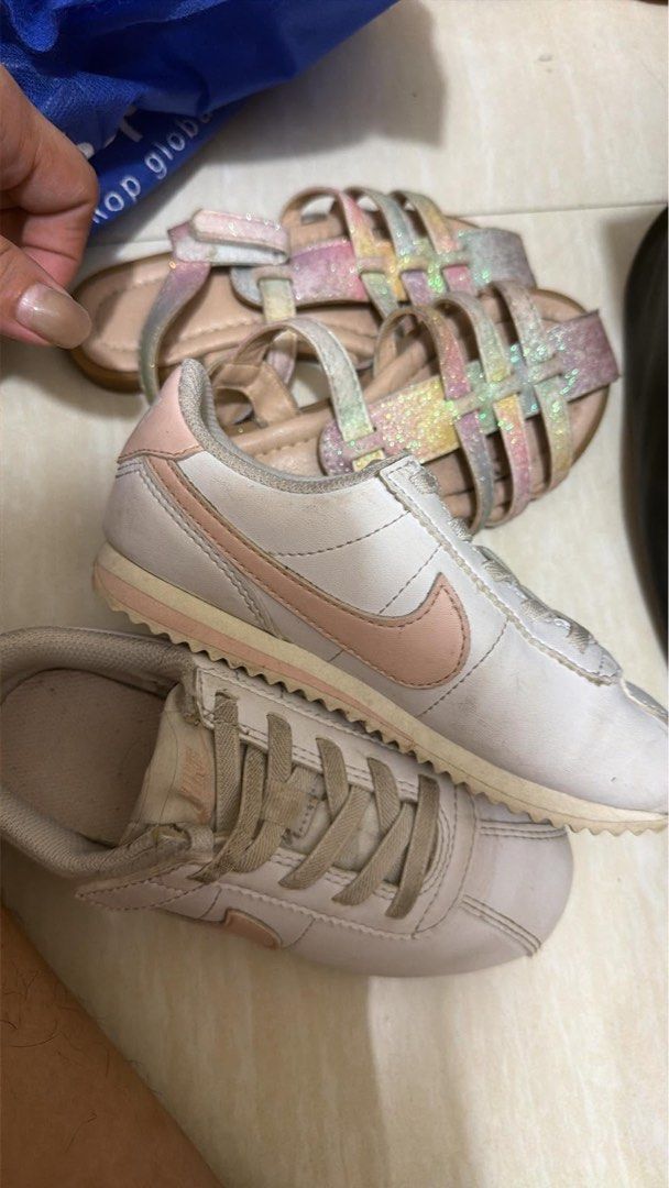 Nike Cortez & Glitter Sandals Bundle (Category: Babies & Kids Fashion) located in Makati City. Submitted by shop4dable (Listing ID 1463226751, Image 1). Description: - Bundle of 2 pairs of kids' shoes - Includes white Nike Cortez with pink accents - Includes sparkly rainbow glitter sandals with adjustable straps - Both shoes have been worn - Great for everyday wear or parties.