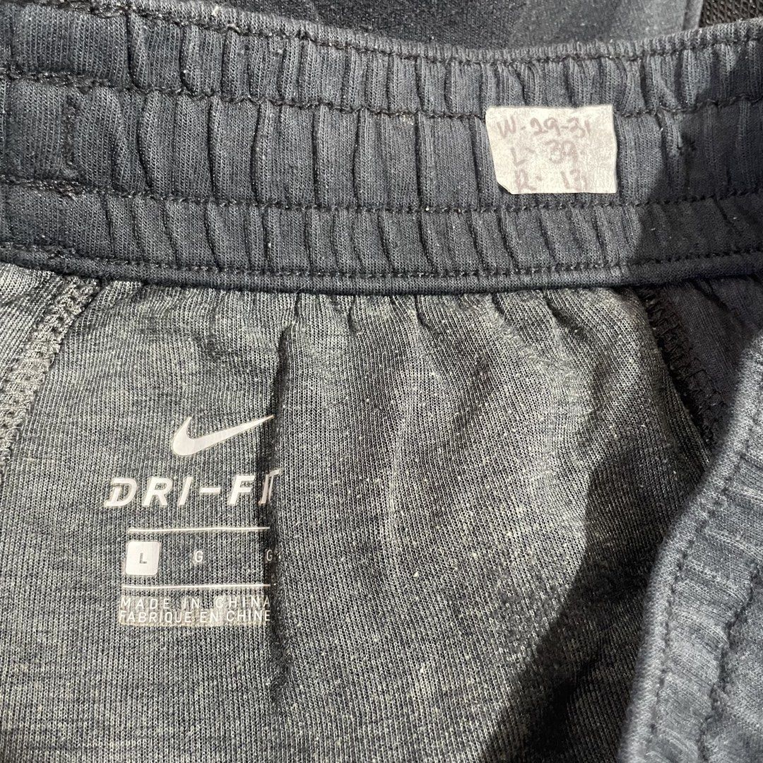 Nike Dri-Fit Jogger Pants Black Size L (Category: Joggers) located in Paombong. Submitted by purefire_ec18f9 (Listing ID 1463158451, Image 3). Description: - Black Nike Dri-Fit Joggers - Size: Large (L) - Features: Elastic waistband with drawstring, side pockets - Design: Mesh paneling on sides with red accents - Versatile: Ideal for workouts or casual wear.