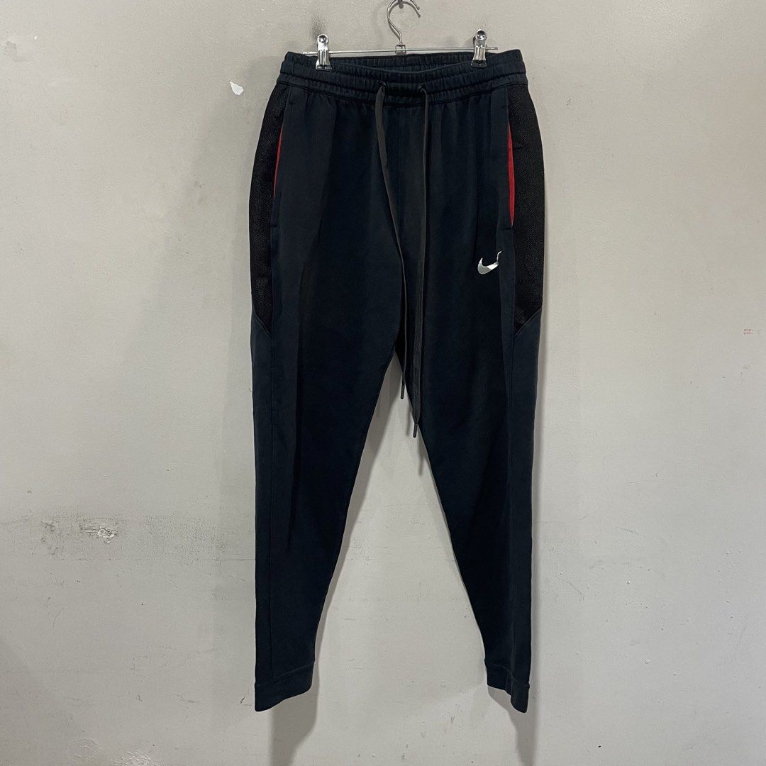 Nike Dri-Fit Jogger Pants Black Size L (Category: Joggers) located in Paombong. Submitted by purefire_ec18f9 (Listing ID 1463158451, Image 1). Description: - Black Nike Dri-Fit Joggers - Size: Large (L) - Features: Elastic waistband with drawstring, side pockets - Design: Mesh paneling on sides with red accents - Versatile: Ideal for workouts or casual wear.