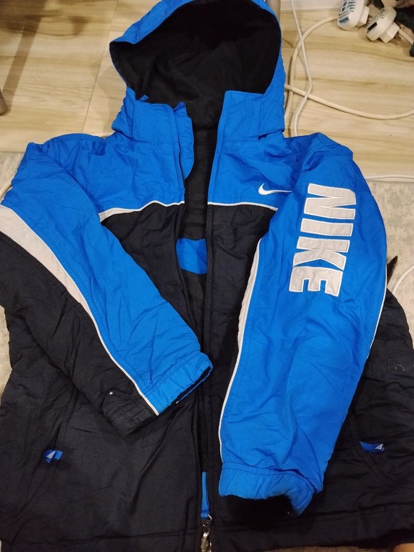 Nike Reversible Hooded Jacket Blue Black Size M (Category: Coats, Jackets and Outerwear) located in Bulacan. Submitted by cjcshop22 (Listing ID 1463178222, Image 1). Description: - Reversible Nike Jacket - Size: Medium (M) - Side 1: Blue with black and white accents - Side 2: Black with blue accents - Nike logo on both sides - Hooded design - Zipper closure - Made in Vietnam.