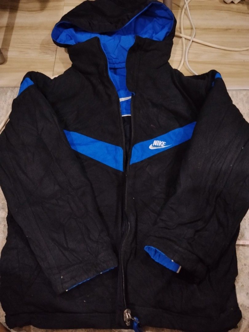 Nike Reversible Hooded Jacket Blue Black Size M (Category: Coats, Jackets and Outerwear) located in Bulacan. Submitted by cjcshop22 (Listing ID 1463178222, Image 2). Description: - Reversible Nike Jacket - Size: Medium (M) - Side 1: Blue with black and white accents - Side 2: Black with blue accents - Nike logo on both sides - Hooded design - Zipper closure - Made in Vietnam.