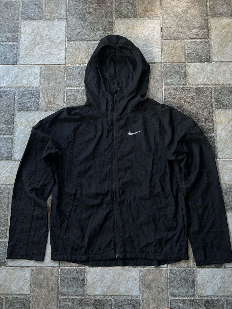 Nike Running Lightweight Hooded Packable Jacket (Category: Coats, Jackets and Outerwear) located in Iriga City. Submitted by thrifttobicol29 (Listing ID 1463201472, Image 1). Description: - Black Nike running jacket - Size: Medium - Lightweight and packable design - Full zip front with adjustable hood - Ideal for running and everyday wear - Made in Vietnam - Nike running packable jacket Medium W 21" L 27-28" Good as new No issue .