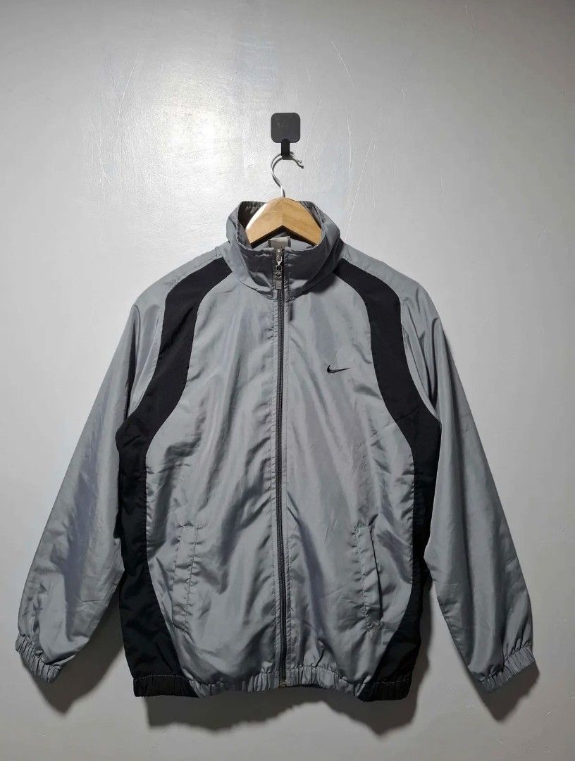 Nike Windbreaker Jacket Grey Black Size M (Category: Coats, Jackets and Outerwear) located in Manila. Submitted by louiefinds26 (Listing ID 1463126196, Image 1). Description: - Nike Windbreaker Jacket - Color: Grey with black side accents - Full zip closure - Elastic cuffs and hem - Lightweight material - Ideal for casual wear or sports - Please check photos for condition details.