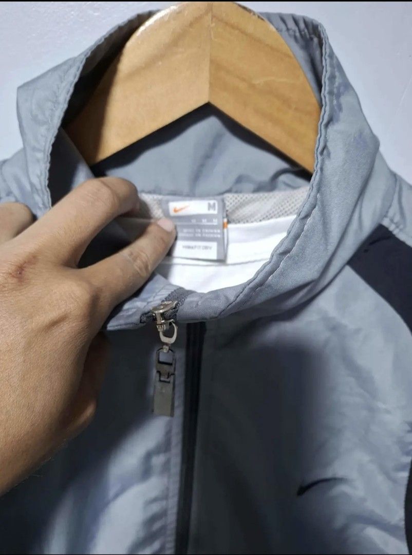 Nike Windbreaker Jacket Grey Black Size M (Category: Coats, Jackets and Outerwear) located in Manila. Submitted by louiefinds26 (Listing ID 1463126196, Image 2). Description: - Nike Windbreaker Jacket - Color: Grey with black side accents - Full zip closure - Elastic cuffs and hem - Lightweight material - Ideal for casual wear or sports - Please check photos for condition details.
