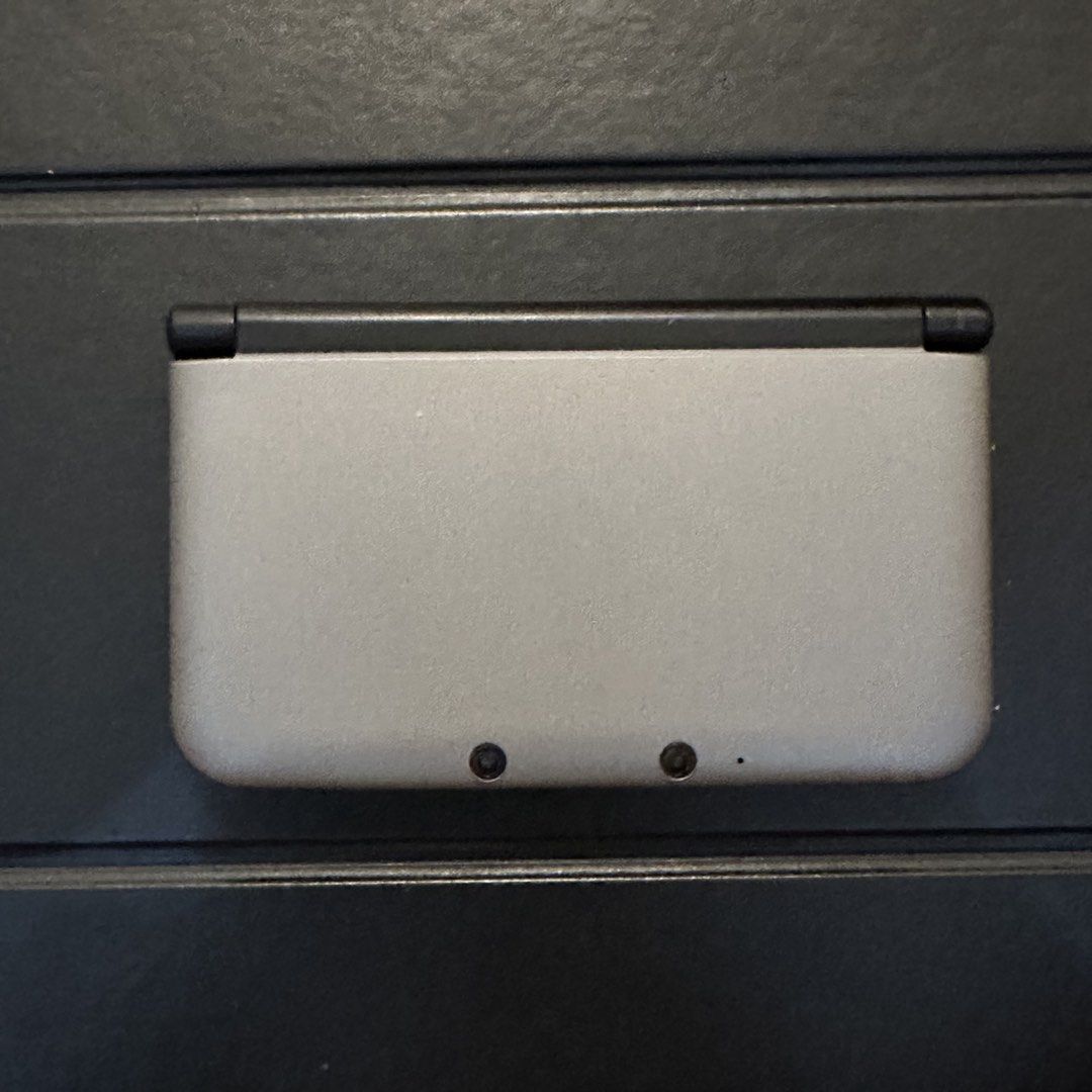 Nintendo 3DS XL Silver Negotiable (Category: Nintendo) located in Quezon City. Submitted by ailoqp (Listing ID 1463273436, Image 2). Description: Nintendo 3DS XL Silver Negotiable Authentic Nintendo 3DS XL handheld console. Shell: Replaced to silver shell Inclusions: Console unit, charger and original shell Condition: Working condition but with minor issues that do not affect gameplay or performance: Screen has light scratches Circle pad missing 
