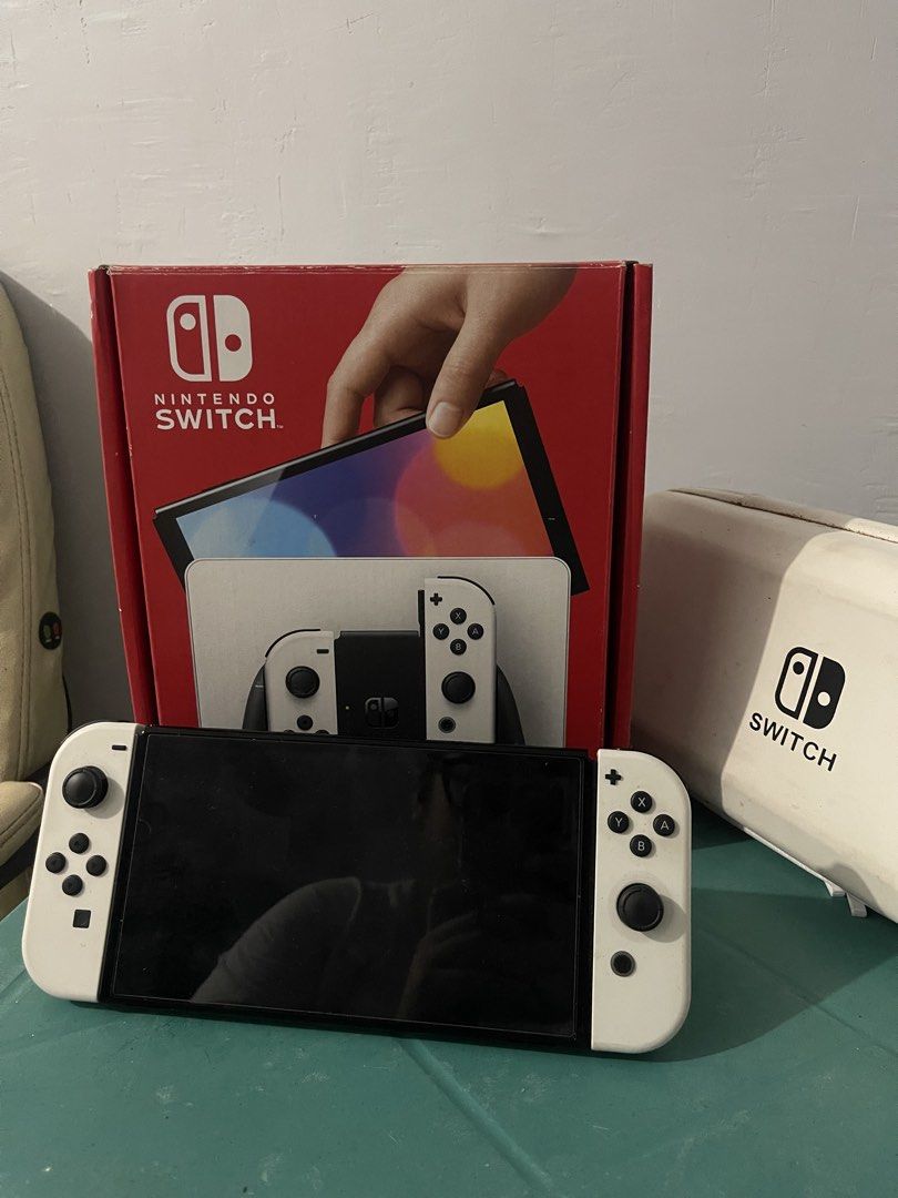 Nintendo Switch OLED Model White - Complete Inclusions (Category: Nintendo) located in Manila. Submitted by ginalinettispaghetticonfetti (Listing ID 1463236056, Image 1). Description: - Nintendo Switch OLED Model (White) - Includes console, Joy-Cons, and dock - Comes with original box - Tempered glass installed !! Inclusive of travel case, Joy-Con cover, 256 GB SD Card, NBA 2K25 !! Available for meetup around MOA & PITX.