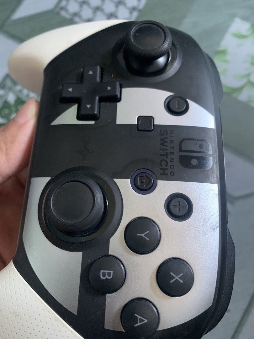 Nintendo Switch Pro Controller - Black/White (Category: Controllers) located in Navotas City. Submitted by recabalesa0 (Listing ID 1463247729, Image 2). Description: - Nintendo Switch Pro Controller - Super mario smash bro edition - Condition: Works great, fully functional Navotas location pickup or lalamove .