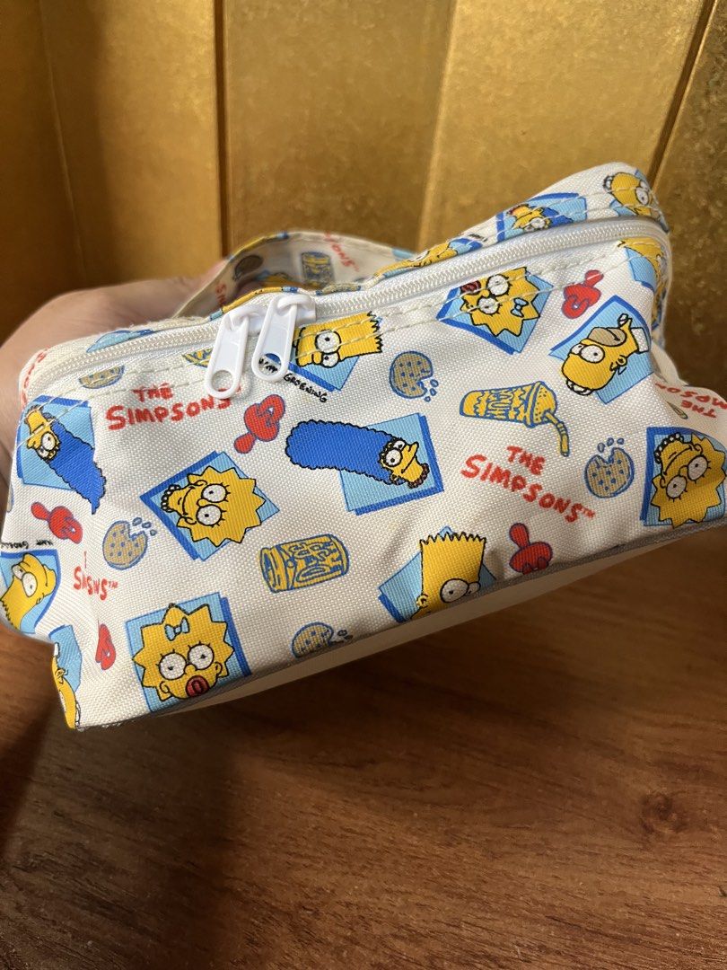 Official The Simpsons Cosmetic Bag Pouch (Category: Purses & Pouches) located in Gapan. Submitted by lunashop14 (Listing ID 1463145604, Image 2). Description: 🍩 Vintage-style The Simpsons Cosmetic PouchGet your hands on this super cute, all-over print makeup/travel bag featuring Maggie and Lisa Simpson! Perfect for any classic 90s cartoon fan. It features a top handle for easy carrying and double zippers.Condition: Great pre-owned condition! Cle