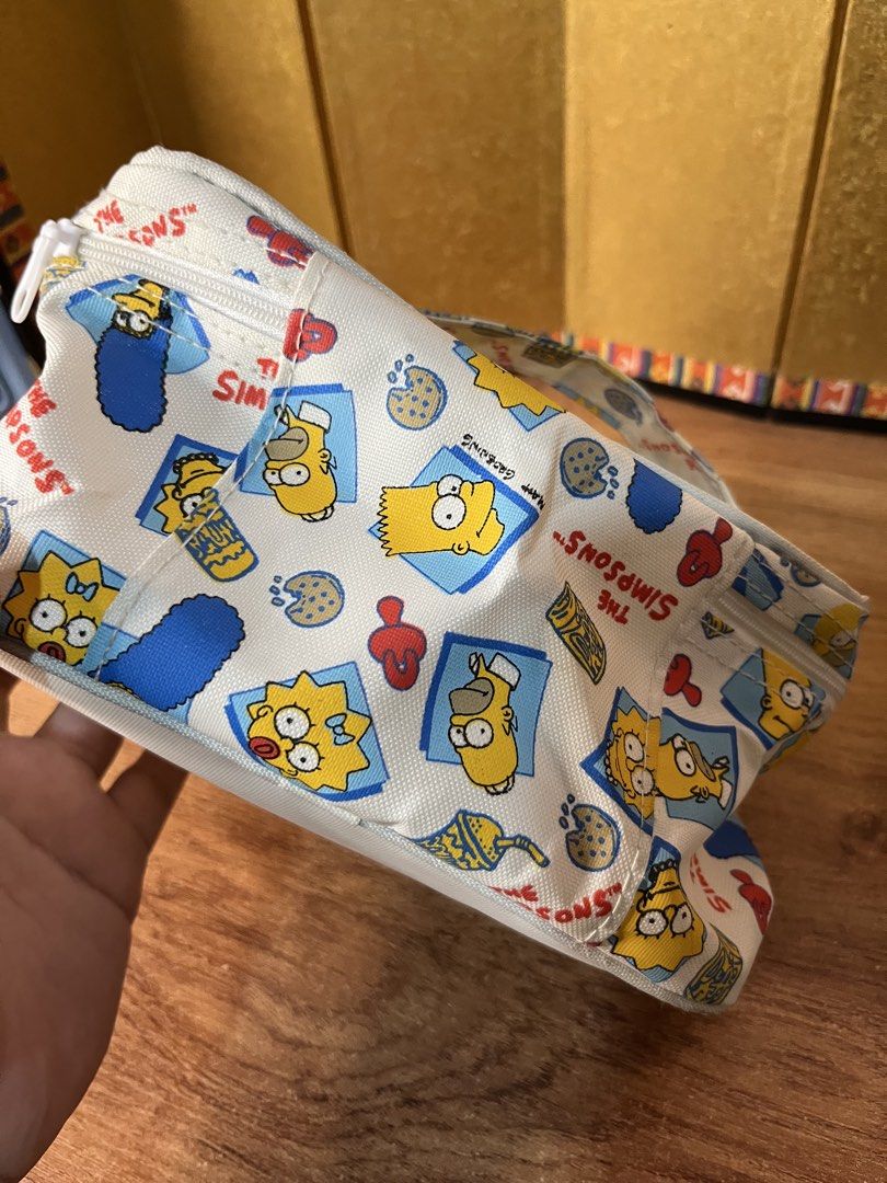 Official The Simpsons Cosmetic Bag Pouch (Category: Purses & Pouches) located in Gapan. Submitted by lunashop14 (Listing ID 1463145604, Image 3). Description: 🍩 Vintage-style The Simpsons Cosmetic PouchGet your hands on this super cute, all-over print makeup/travel bag featuring Maggie and Lisa Simpson! Perfect for any classic 90s cartoon fan. It features a top handle for easy carrying and double zippers.Condition: Great pre-owned condition! Cle