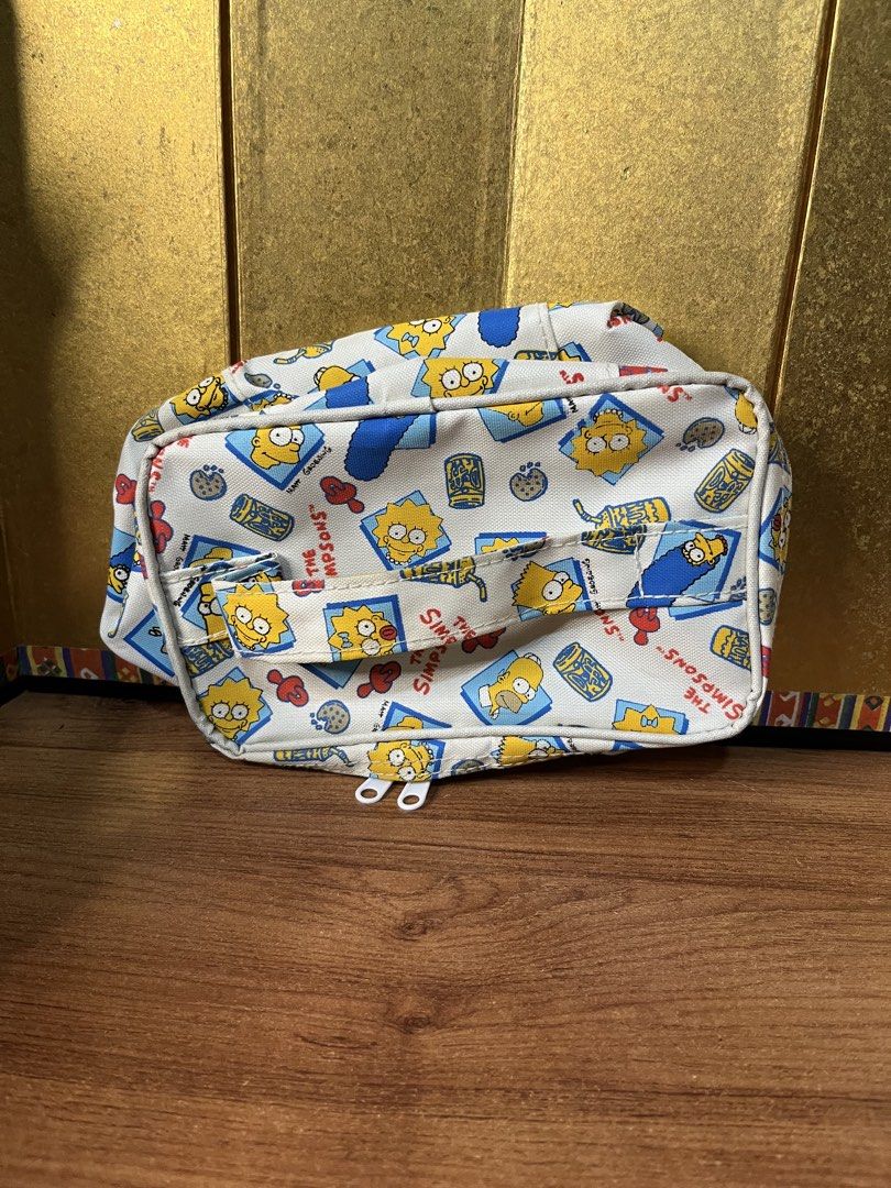 Official The Simpsons Cosmetic Bag Pouch (Category: Purses & Pouches) located in Gapan. Submitted by lunashop14 (Listing ID 1463145604, Image 1). Description: 🍩 Vintage-style The Simpsons Cosmetic PouchGet your hands on this super cute, all-over print makeup/travel bag featuring Maggie and Lisa Simpson! Perfect for any classic 90s cartoon fan. It features a top handle for easy carrying and double zippers.Condition: Great pre-owned condition! Cle