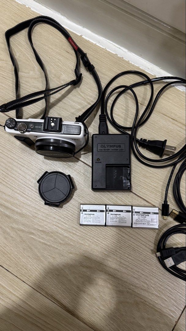 Rare Olympus XZ-1 White Digital Camera + 3 Batteries & Accessories (Category: Cameras) located in Quezon City. Submitted by niksellsss (Listing ID 1463288317, Image 3). Description: Rare white Olympus XZ-1 digital camera set. Tested and working. Camera, lens, zoom, flash, buttons, screen, and battery charging are functional. Included: - Olympus XZ-1 White - 3 Olympus batteries - Original battery charger - Lens cap - Camera strap - Cables shown in