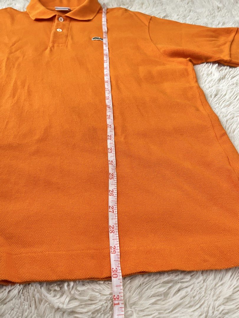 Orange Lacoste Polo Shirt Size 6 (Category: Tshirts & Polo Shirts ) located in General Santos City (Dadiangas). Submitted by crisjayg (Listing ID 1463324610, Image 2). Description: - Classic orange Lacoste polo shirt - Features iconic crocodile logo on chest - Made in El Salvador - Tag size: 6 - Measurements: Approx. 30" length, 22" chest - Ideal for casual wear or a sporty look.