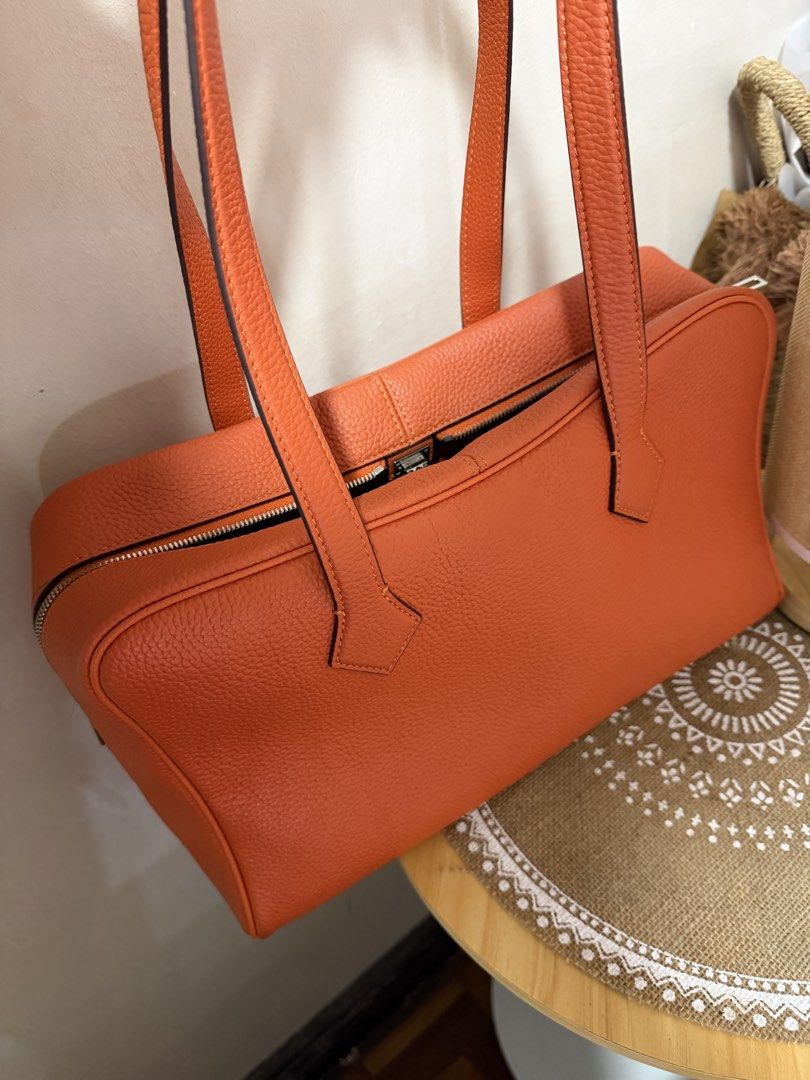 Orange Leather Handbag with Lock and Key (Category: Luxury Bags & Wallets) located in Manila. Submitted by madsdedios05212 (Listing ID 1463231915, Image 3). Description: - Vibrant orange textured leather handbag - Secure zipper closure with included lock and key - Comfortable top handles for easy carrying - Detachable strap for versatile wear - Spacious interior to hold all your essentials - Ideal for everyday use.