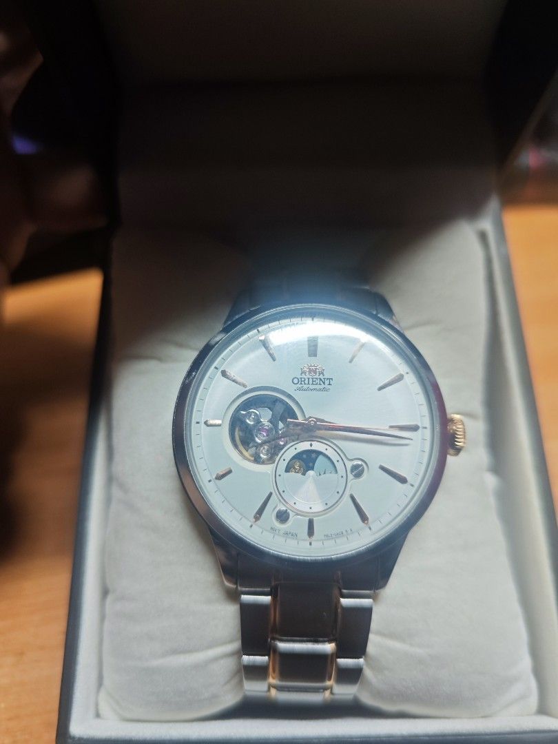 Orient Automatic Watch with Open Heart Dial (Category: Men's Watches) located in Manila. Submitted by Irvi13488 (Listing ID 1463233152, Image 2). Description: - Orient automatic watch - Open heart dial showcasing the movement - Silver and gold tone stainless steel bracelet - Moon phase complication at 6 o'clock - Made in Japan - Comes with original box -Complete papers and receipt.
