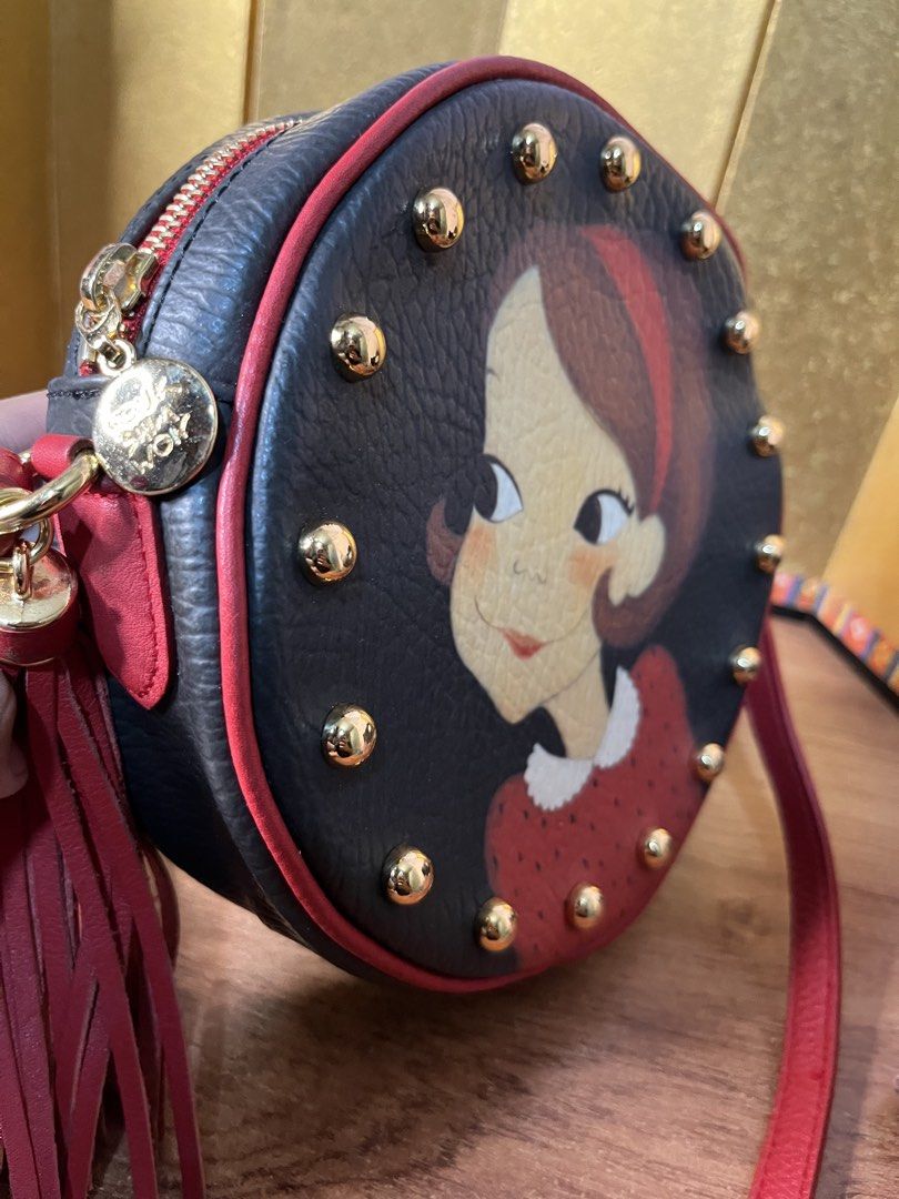 Original YOUK SHIM WON Sling Bag (Category: Cross-body Bags) located in Gapan. Submitted by lunashop14 (Listing ID 1463145084, Image 3). Description: Collector’s piece! 🎨✨ Selling this gorgeous authentic Youk Shim Won round crossbody bag. It features the brand’s iconic, playful character portrait framed by edgy gold-toned studs and a statement red leather tassel. Perfect for adding a pop of color and artistic flair to any outfit.🎒 Compact round