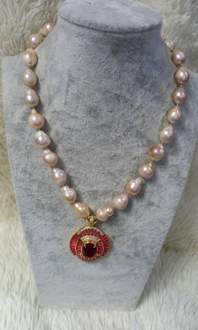 Peach Baroque with big pendant precious stone (Category: Necklaces) located in Malabon City. Submitted by aishahgirlshop (Listing ID 1463280794, Image 3). Description: 💯 Authentic fresh water pearl Baroque peach tone big size precious stone vermiel setting non tarnish garnet and blue sapphire each necklace cost 10k with Authenticity card and box Gcash payment only best deal for 8500 only.